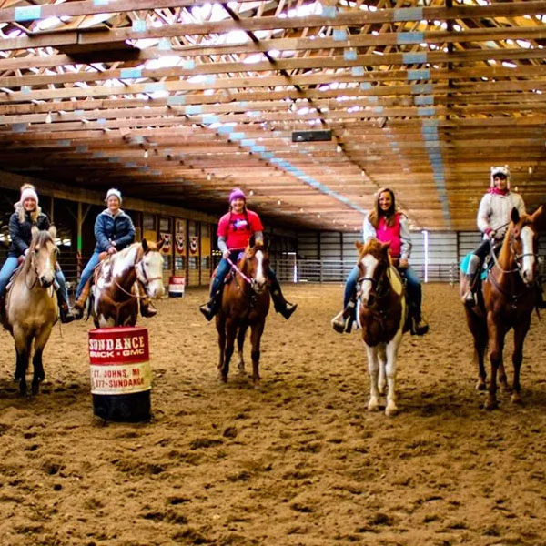 group on horses in arena